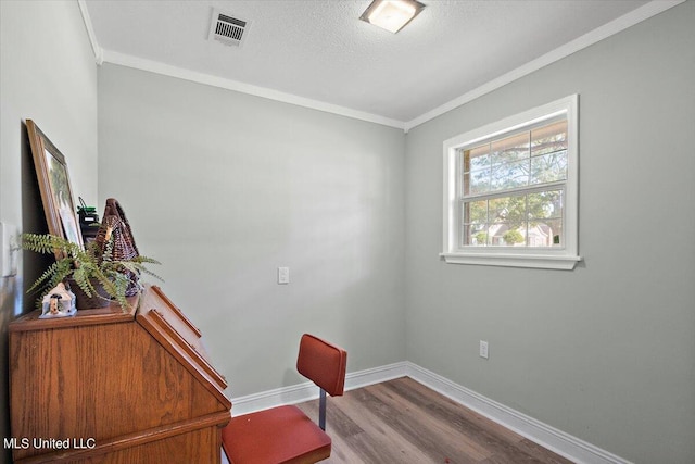 home office with crown molding, hardwood / wood-style flooring, and a textured ceiling