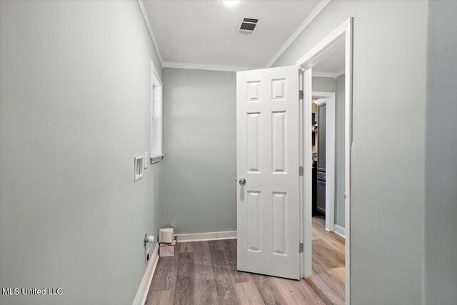 hall with crown molding and hardwood / wood-style flooring