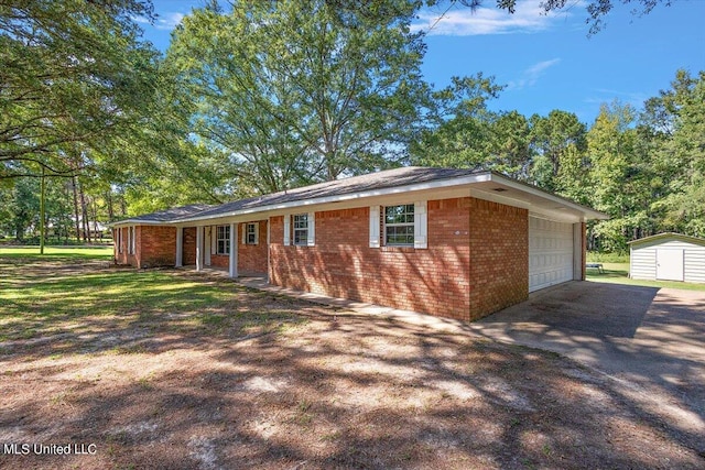 single story home featuring an outbuilding and a garage