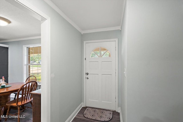 foyer with ornamental molding, hardwood / wood-style flooring, and a healthy amount of sunlight