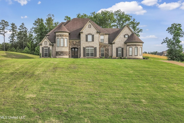 french country style house featuring a front lawn and brick siding