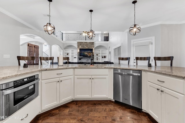 kitchen featuring dishwasher, a sink, crown molding, arched walkways, and pendant lighting