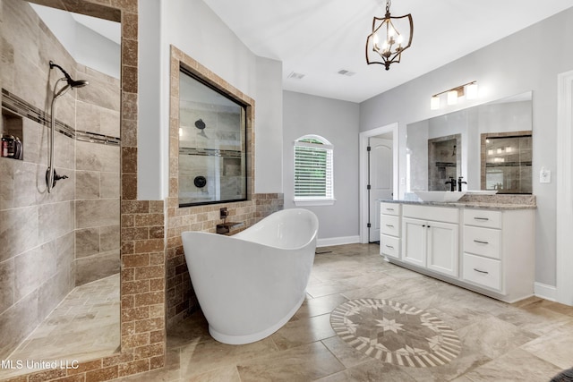 bathroom with walk in shower, a soaking tub, vanity, a chandelier, and tile walls