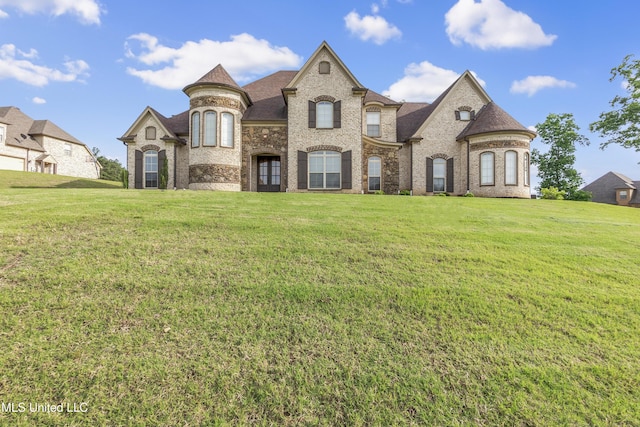 french country style house with a front lawn and brick siding