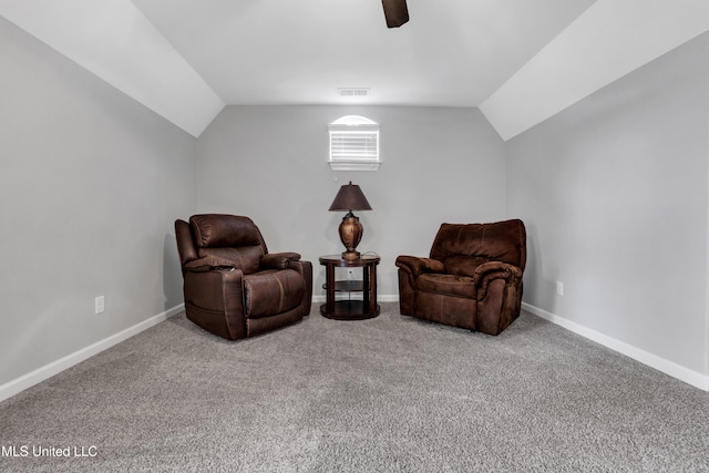 living area featuring lofted ceiling, carpet flooring, baseboards, and a ceiling fan