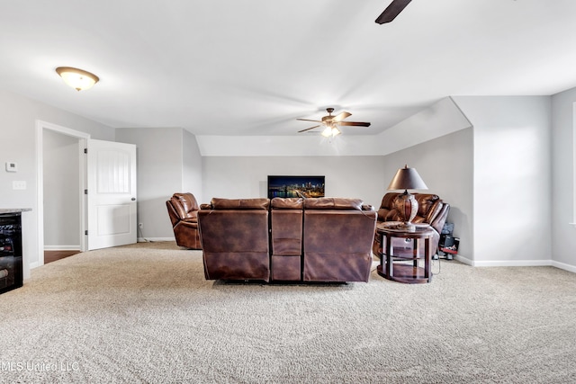 living area with ceiling fan, carpet, and baseboards