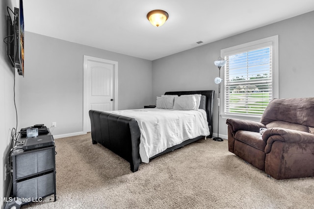 bedroom with carpet flooring and baseboards