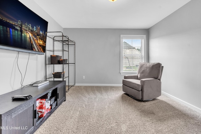 living area with baseboards and carpet floors