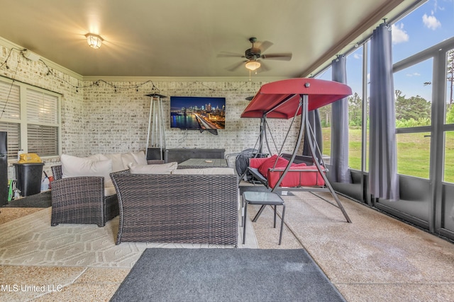 sunroom / solarium with ceiling fan and an outdoor living space