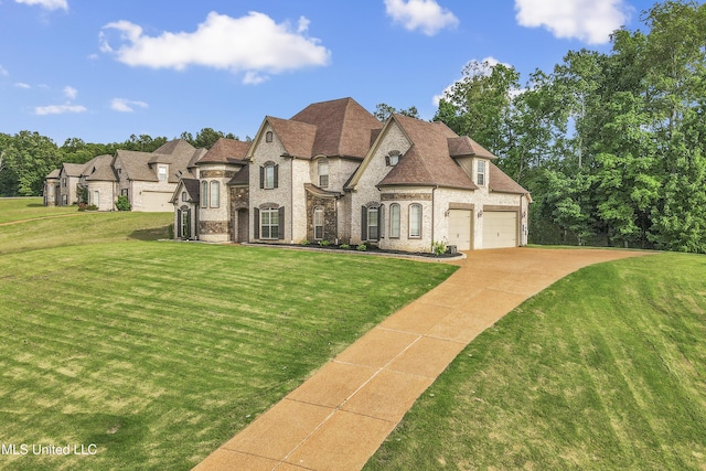french provincial home with driveway, a front lawn, and brick siding