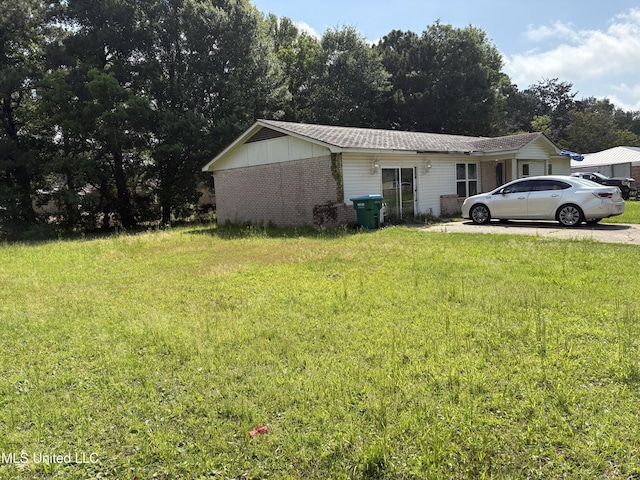 view of home's exterior with a yard and brick siding
