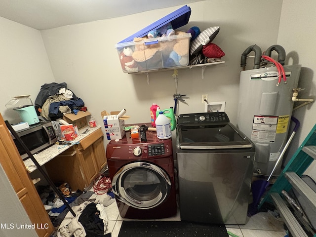 clothes washing area with water heater, washing machine and dryer, and laundry area