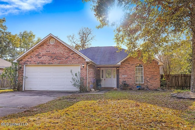 view of front of property featuring a front yard and a garage