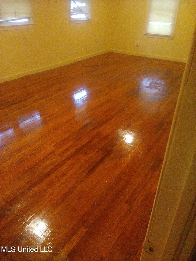 empty room with hardwood / wood-style flooring