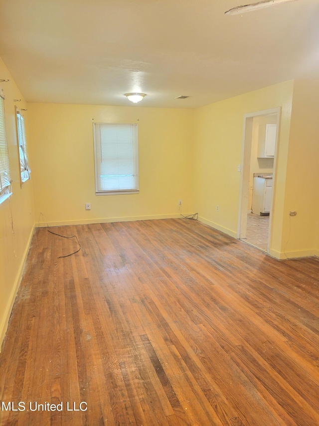 empty room with wood-type flooring