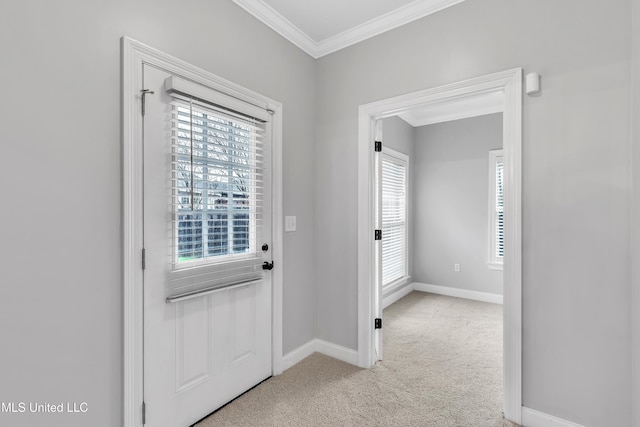 entryway with ornamental molding and light carpet