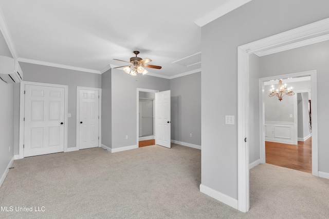 unfurnished bedroom with a wall mounted air conditioner, ornamental molding, light carpet, ceiling fan with notable chandelier, and multiple closets