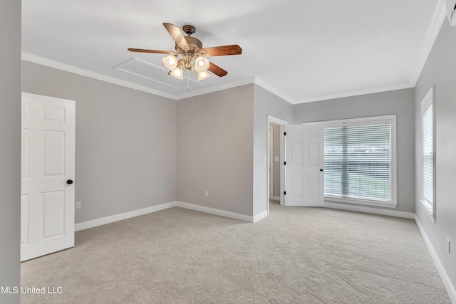 carpeted spare room with crown molding and ceiling fan