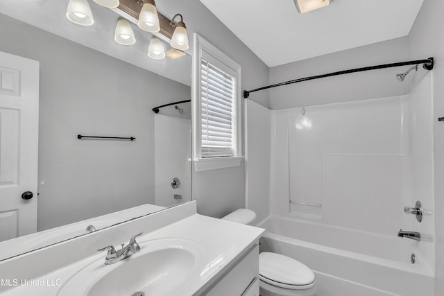 full bathroom featuring vanity, washtub / shower combination, and toilet