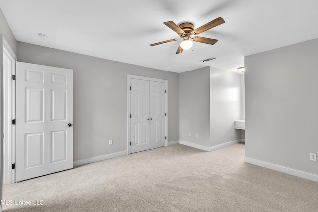 unfurnished bedroom featuring light carpet and ceiling fan