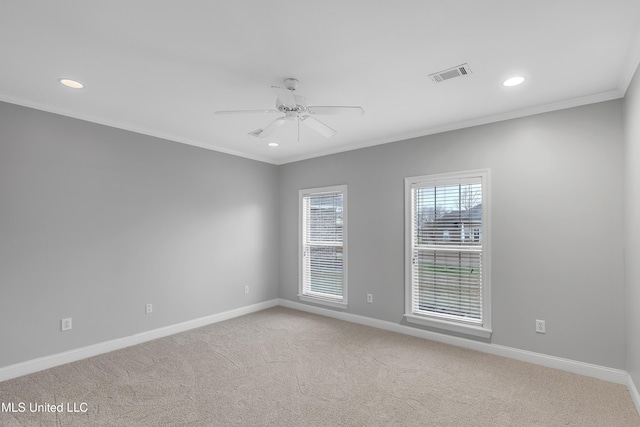 carpeted empty room featuring crown molding and ceiling fan