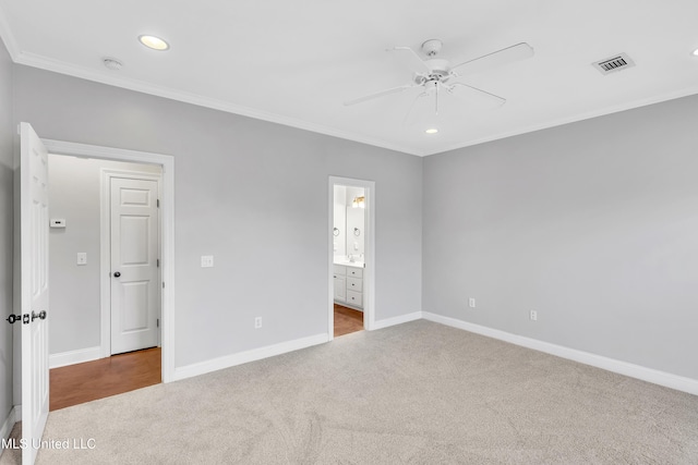 unfurnished bedroom with connected bathroom, crown molding, light colored carpet, and ceiling fan