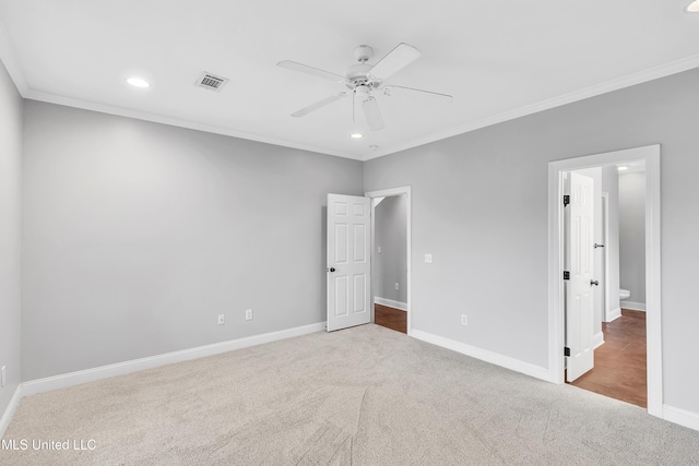 unfurnished bedroom featuring crown molding, light colored carpet, and ceiling fan