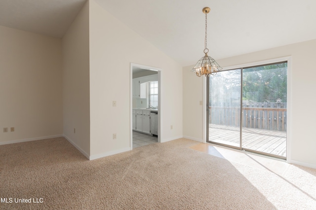 unfurnished room with a chandelier, light carpet, lofted ceiling, and a healthy amount of sunlight