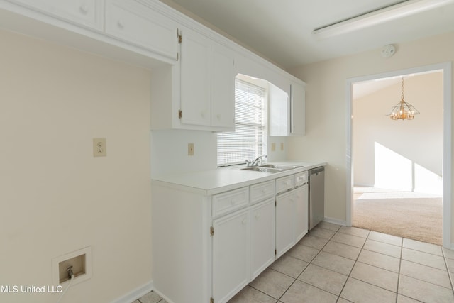 kitchen with dishwasher, white cabinets, sink, hanging light fixtures, and light tile patterned flooring