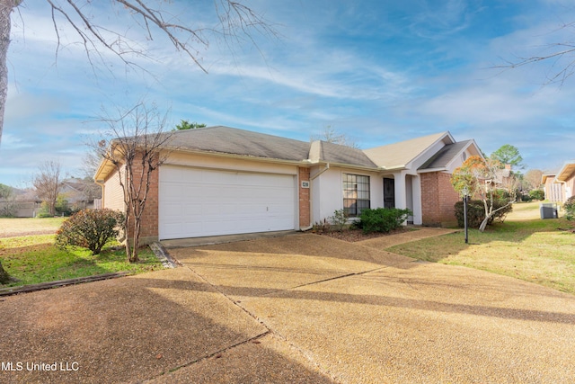 single story home featuring cooling unit, a garage, and a front yard