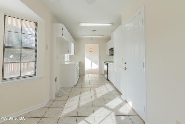 hallway featuring light tile patterned floors and sink