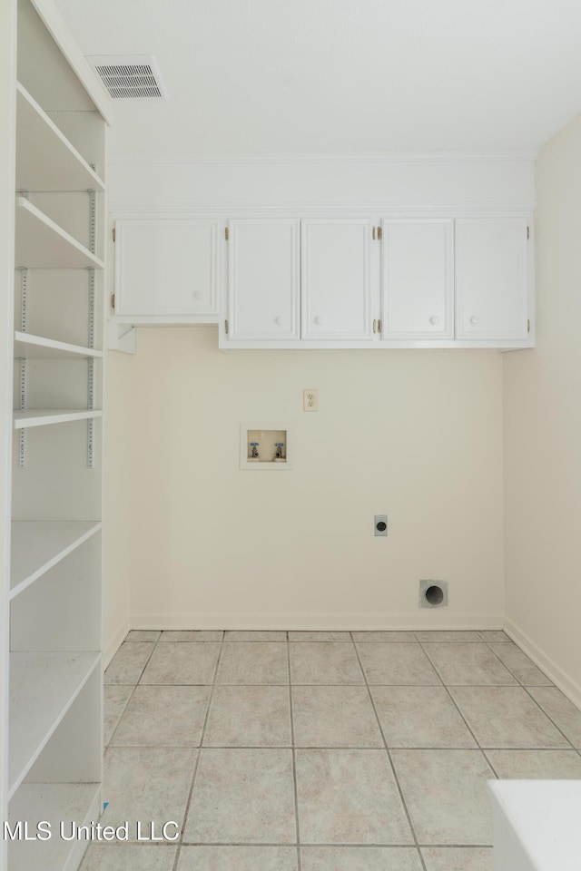 clothes washing area with cabinets, washer hookup, light tile patterned floors, and electric dryer hookup