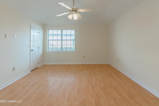 spare room with ceiling fan, lofted ceiling, and light hardwood / wood-style flooring