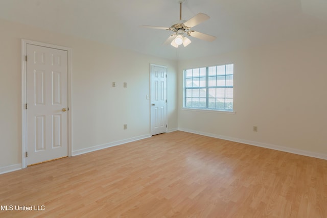 empty room with light wood-type flooring and ceiling fan