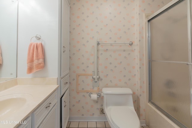 full bathroom with tile patterned floors, vanity, combined bath / shower with glass door, and toilet