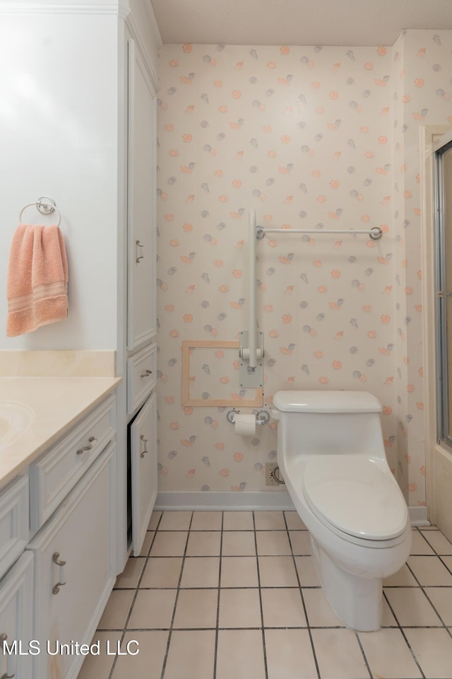 bathroom with tile patterned flooring, vanity, and toilet