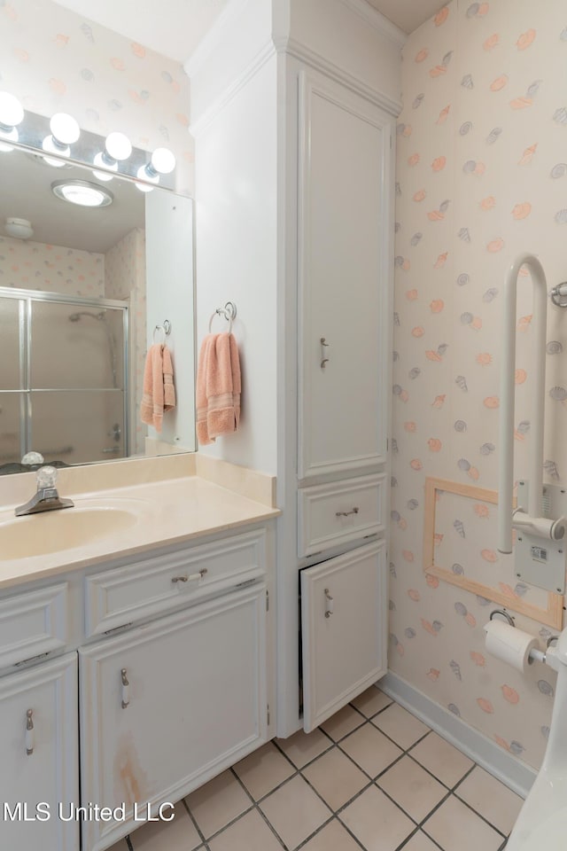 bathroom with tile patterned flooring, vanity, and an enclosed shower