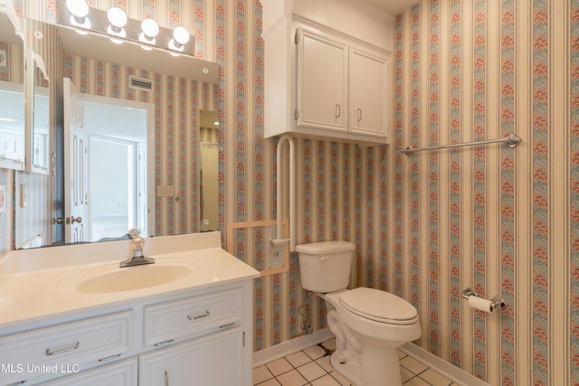 bathroom featuring tile patterned flooring, vanity, and toilet