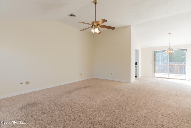 spare room with carpet, ceiling fan with notable chandelier, and vaulted ceiling