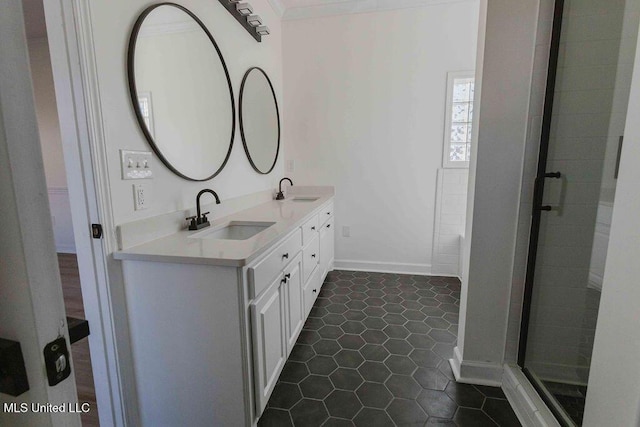 full bathroom featuring double vanity, tile patterned flooring, a shower stall, and a sink