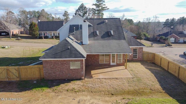 back of property featuring brick siding, a patio area, and a fenced backyard