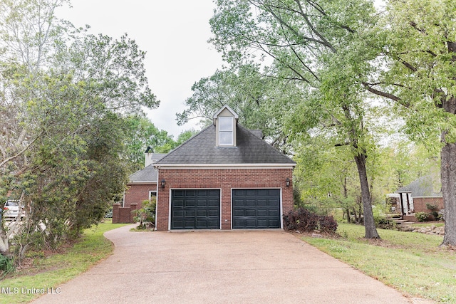 exterior space with brick siding, a front lawn, a shingled roof, and driveway