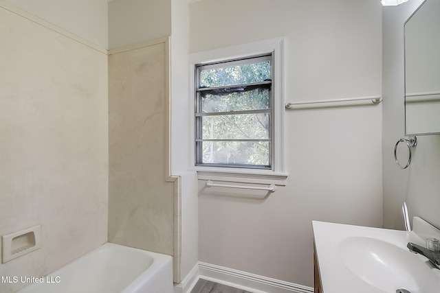 bathroom featuring washtub / shower combination, hardwood / wood-style floors, and vanity