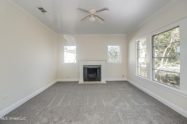 unfurnished living room featuring ceiling fan, carpet floors, and ornamental molding