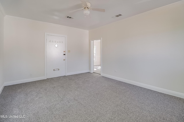 empty room with carpet flooring, ceiling fan, and ornamental molding