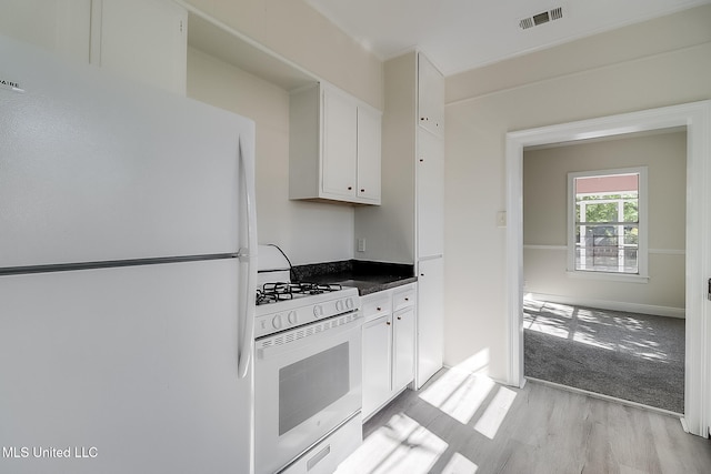 kitchen featuring white cabinetry, white appliances, and light wood-type flooring