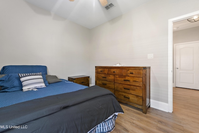 bedroom with visible vents, ceiling fan, light wood-style flooring, and baseboards