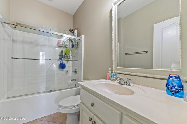 bathroom featuring tile patterned flooring, shower / bath combination with glass door, vanity, and toilet