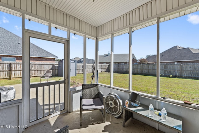 sunroom / solarium featuring a residential view