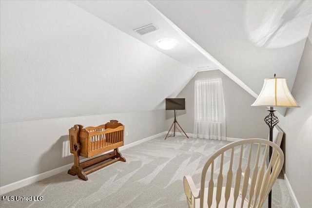 sitting room featuring carpet floors, lofted ceiling, visible vents, and baseboards